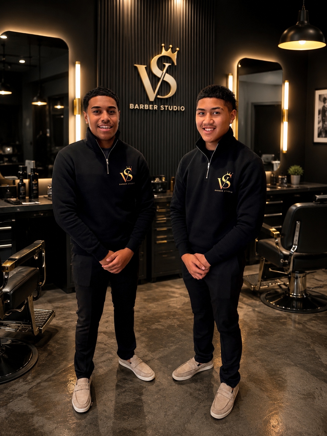 The VS Barber Studio team standing in the studio beneath the gold VS crown logo
